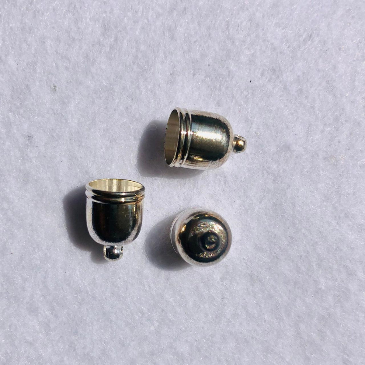 (TRM0004) Tapa Borla Oval con raya 10 mm color oro 25 pz